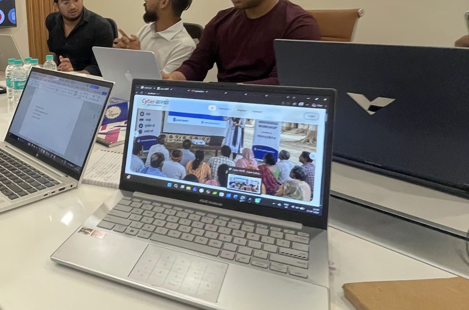 The Cyber सारथी platform open in a browser during a review session, showing the landing page with a photo from an awareness workshop.