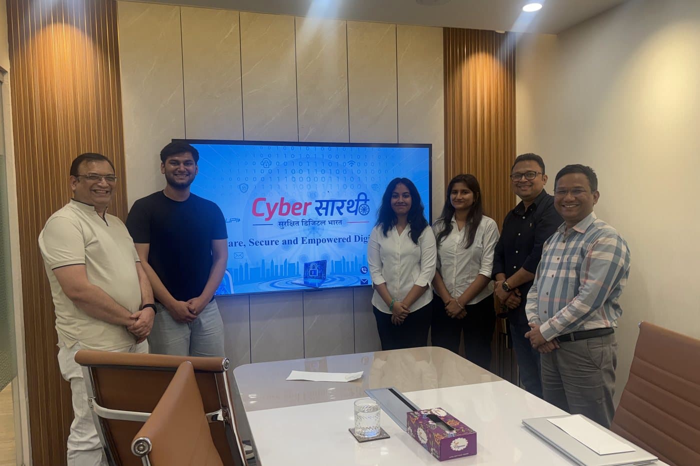 The Cyber सारथी team in front of a screen showing the project's branding at the MeraPath office.